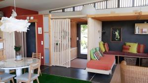 a living room with a couch and a table at Gite Dilos in Gan