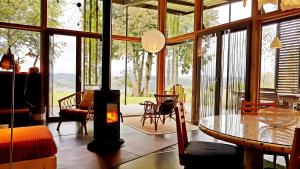 a living room with a fireplace and a table and chairs at Gite Dilos in Gan