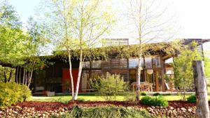 a house with a green roof and trees at Gite Dilos in Gan
