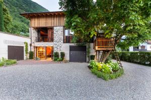 a house with a tree in the driveway at Innerbachlerhof - Laugen in Postal