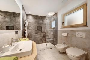 a bathroom with a sink and a toilet and a shower at Masi Rosmarin in Santa Valpurga +13 photos