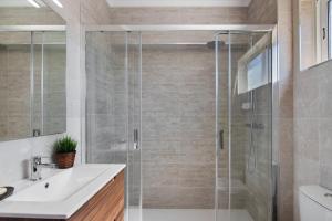 a bathroom with a shower and a sink at Justo's House in Faro +18 photos