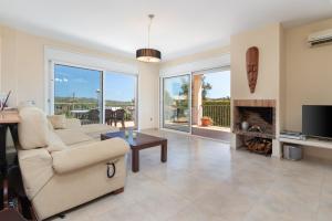 a living room with a couch and a fireplace at Villa Elodia in Calonge