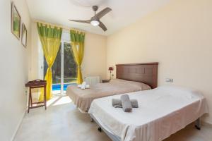 a bedroom with two beds and a window at Villa Elodia in Calonge +22 photos
