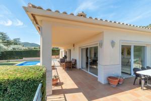 a house with a patio and a swimming pool at Villa Elodia in Calonge
