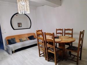 a dining room with a table and a bed at Séjour familial au Gite Iza – Lorme in Lormes