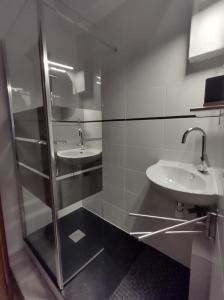 a bathroom with two sinks and a shower at Séjour familial au Gite Iza – Lorme in Lormes +25 photos