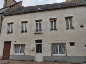 an old brick building with windows and a door at Séjour familial au Gite Iza – Lorme in Lormes