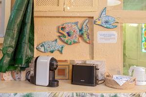 a counter with a toaster and a printer on a shelf at Stanza Verde degli Artisti in Rosignano Marittimo