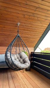 a hammock hanging from a roof on a porch at Studio Dinkelberg in Adelhausen