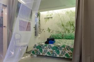 a bedroom with a bed with a teddy bear on it at Stanza Verde degli Artisti in Rosignano Marittimo +14 photos
