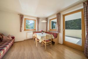 a living room with a table and a couch at Ferienhaus Maria Edelweiss in Moso