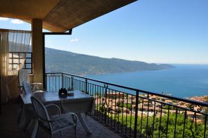a balcony with a table and chairs and the ocean at Stella del Garda 1 con balcone in Tignale