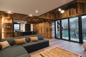 a living room with a couch and a table at Gîte Maria in La Tour