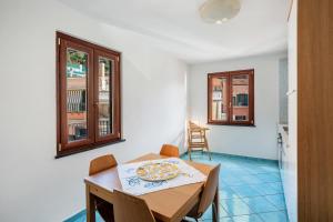 a room with a table with a pizza on it at Ce Tour - Casa Cetara Centro in Cetara +10 photos