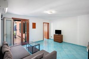 a living room with a couch and a tv at Ce Tour - Casa Cetara Centro in Cetara