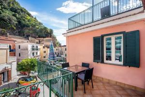 a balcony with a table and chairs on a building at Ce Tour - Casa Cetara Centro in Cetara
