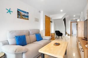 a living room with a couch and a table at Casa Pera in Xilxes