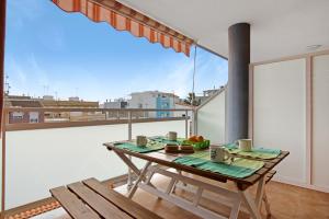 a table on a balcony with a view of a city at Casa Pera in Xilxes