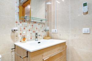 a bathroom with a sink and a mirror at Casa Pera in Xilxes +13 photos