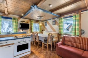 a kitchen and dining room with a table and a couch at Chalet Berger in Sankt Johann im Pongau