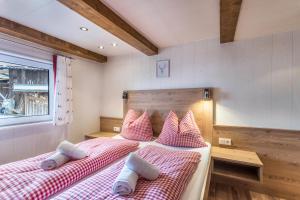 a bedroom with two beds with red and white pillows at Chalet Berger in Sankt Johann im Pongau +13 photos