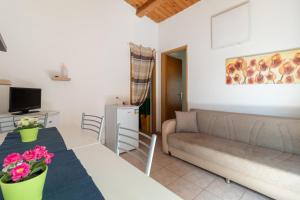 a living room with a couch and a table at Villa Arianna in Ragusa