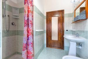 a bathroom with a sink and a toilet and a shower at House Leoni in Isola Rossa +46 photos