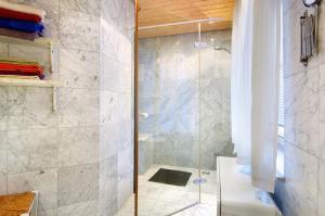 a shower with a glass door in a bathroom at Ferienhaus Reis in Ostrach +18 photos