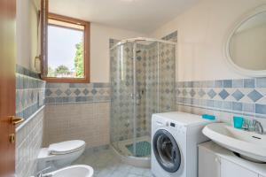 a bathroom with a washing machine and a sink at Villetta Allegra in Prataccio +12 photos