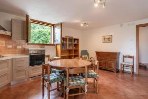 a kitchen with a table and chairs and a window at Villetta Allegra in Prataccio
