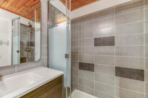 a bathroom with a white tub and a sink at Gawal 1 in Villard-Reculas
