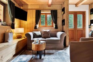 a living room with a couch and a table at Baita Valon - Alpine Hideaway in Comano Terme