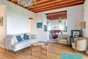 a living room with a couch and a table at Villa Lin et Maree face océan in Le Croisic +21 photos