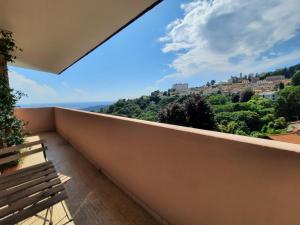 a balcony with a bench and a view at Attico Panoramico in Brunate