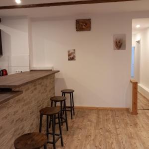 a bar with stools in a room with white walls at Ferienwohnung 1 Bartölke in Bockenem