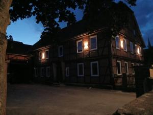 a house with lights on the windows at night at Ferienwohnung 1 Bartölke in Bockenem