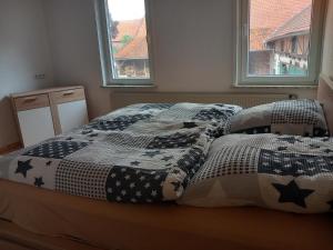 a bed with a comforter and pillows in a bedroom at Ferienwohnung 1 Bartölke in Bockenem