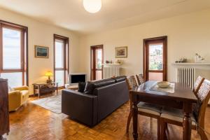 a living room with a couch and a table at Attico Panoramico in Brunate