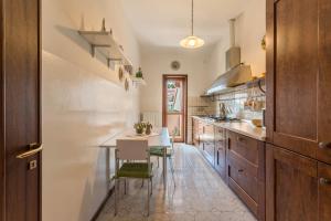 a kitchen with a table and chairs in a room at Attico Panoramico in Brunate