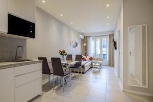 a kitchen and living room with a table and a couch at Appartement Sea View in Nice