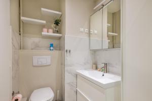 a bathroom with a sink and a toilet and a mirror at Appartement Sea View in Nice +14 photos