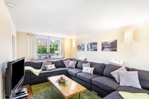 a living room with a couch and a tv at Haus Lindenfürst in Olsberg
