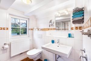 a white bathroom with a sink and a toilet at Haus Lindenfürst in Olsberg +37 photos