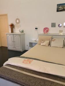 a bedroom with a large white bed with pillows at Villa Maria in Cap Skirring