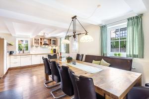 a kitchen and dining room with a wooden table and chairs at Haus Lindenfürst in Olsberg