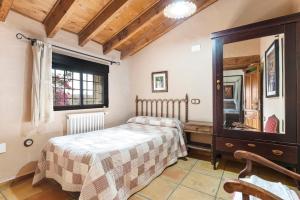 a bedroom with a bed and a dresser and a mirror at La Carrasca - Limón in Catral +24 photos
