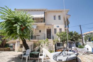 a house with a boat in front of it at M1 room in Nikiana +10 photos