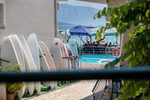 a row of surfboards are lined up next to a pool at M1 room in Nikiana