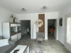 a living room with a couch and a chair at Ferienwohnung Sonnenhöhe in Greiz